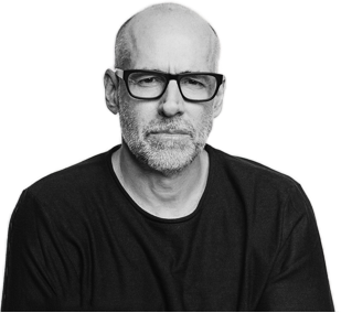 Bald man with glasses wearing a black shirt.